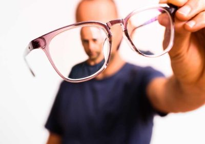 Man holding Astigmatism glasess