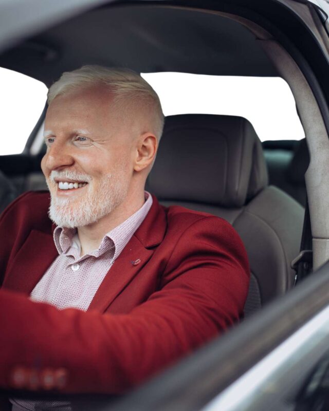 A man happily driving after cataract surgery